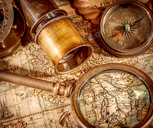 Preview: Vintage style travel and adventure. Vintage old compass and other vintage items on the table.