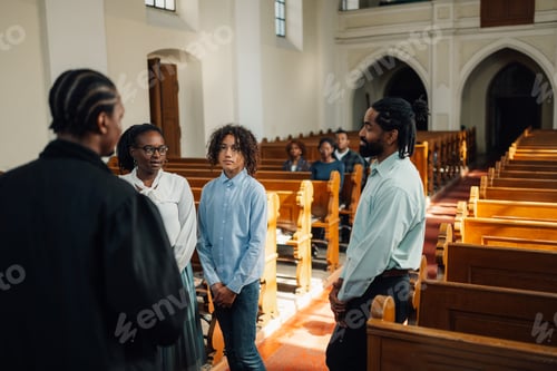Preview: African american family standing and listening to priest in church