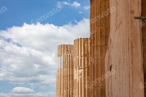 Preview: Athens, Greece. Propylaea columns in the Acropolis, blue cloudy sky in spring sunny day.