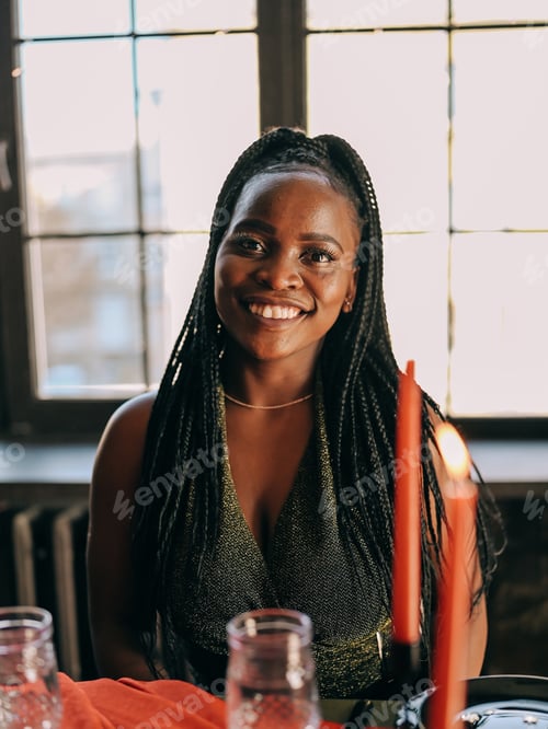 Preview: Beautiful young black woman portrait on the friends indoors party Christmas winter holiday dinner
