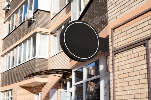 Preview: Black round logo on brick wall building exterior for mockup design