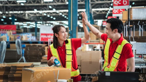 Preview: Warehouse worker checking details stock product and scanning a barcode on box package.