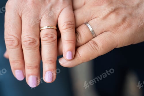 Preview: Married mature old couple holding hands with rings ceremony wedding day