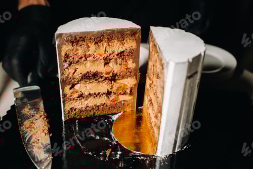 Preview: Amazing Cakes. Sliced chocolate wedding cake cake with amazing filling on a black background.Large