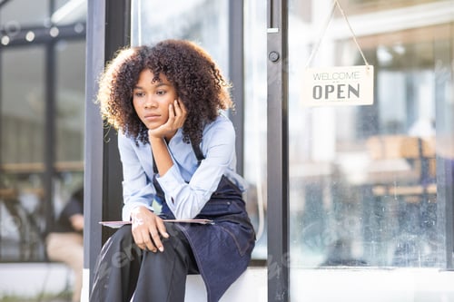Preview: Portrait of Young african american small business owner woman wearing apron and looking away to you