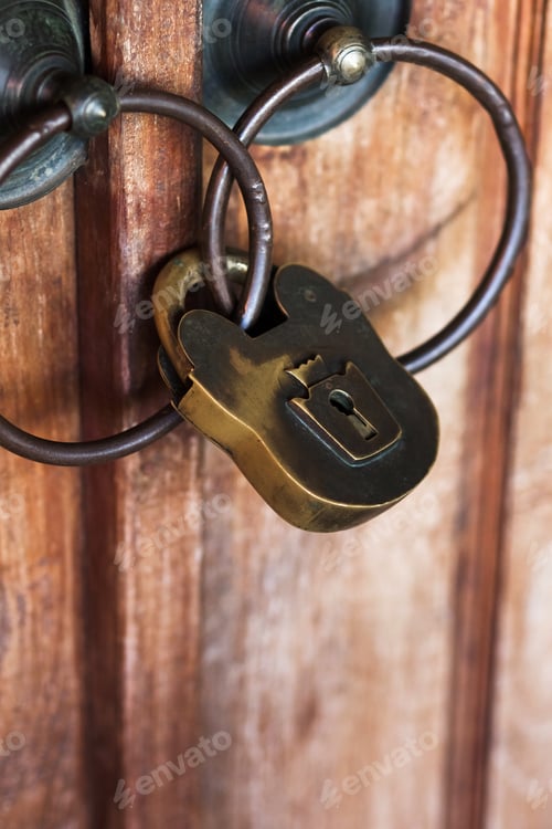 Preview: Big iron padlock on vintage wooden door