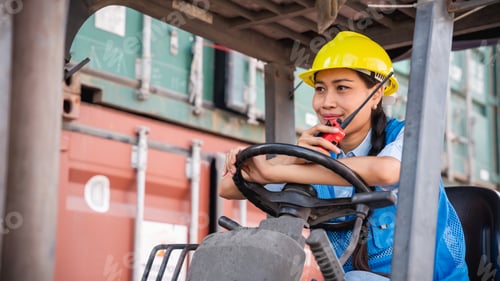 Preview: Engineer or foreman working and use talkie with a forklift in at container yard.