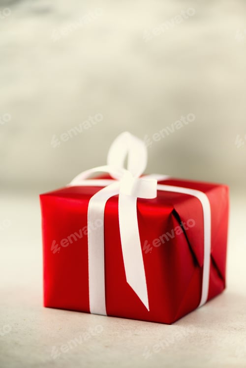 Preview: Red gift box on grey concrete background, copy space. Christmas, new year, birthday party, valentine