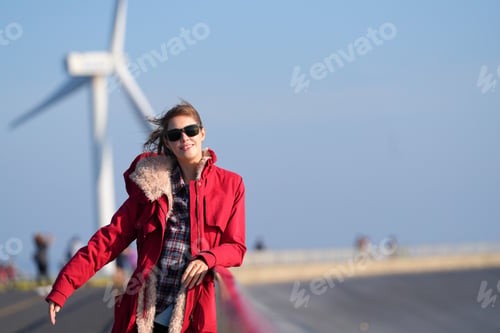 Preview: A Beautiful Woman Taking Selfies, wind turbine In Background