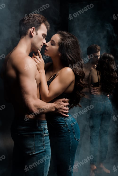 Preview: beautiful sexy couple hugging and going to kiss near mirror