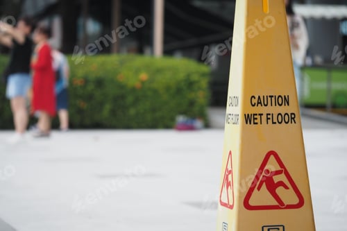 Preview: Caution sign alerts about wet floor in busy area