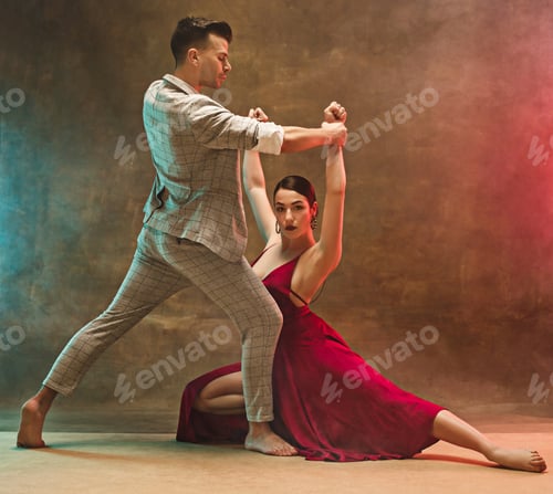 Preview: Flexible young modern dance couple posing in studio.