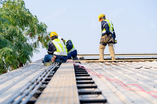 Preview: workers installing solar panels, for efficient energy on rooftop