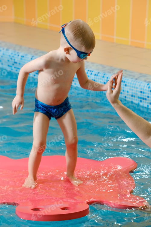 Preview: Toddler child trained to dive in indoor swimming pool