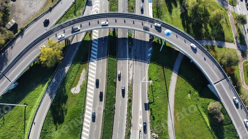 Preview: Aerial view of a highway intersection with cars driving on a bright sunny day