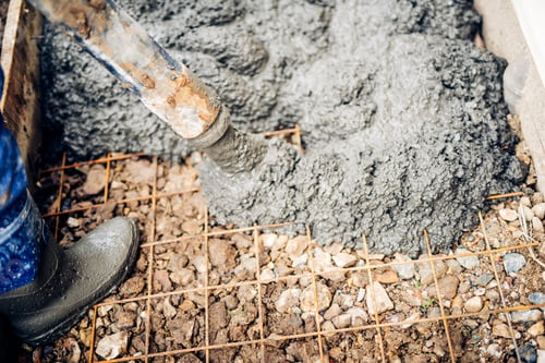 Preview: close up of construction workers using cement pump tube