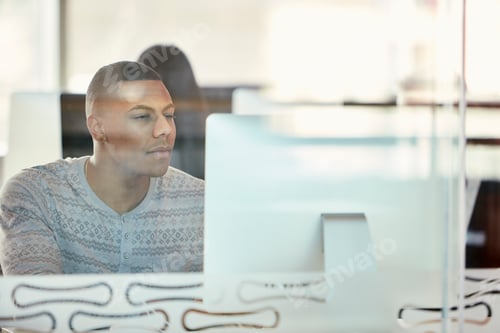Preview: University student working at computer behind glass partition