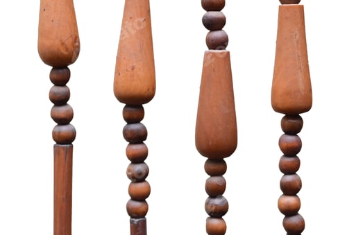 Preview: The image depicts a close-up of a wooden beaded curtain hanging against a white background.