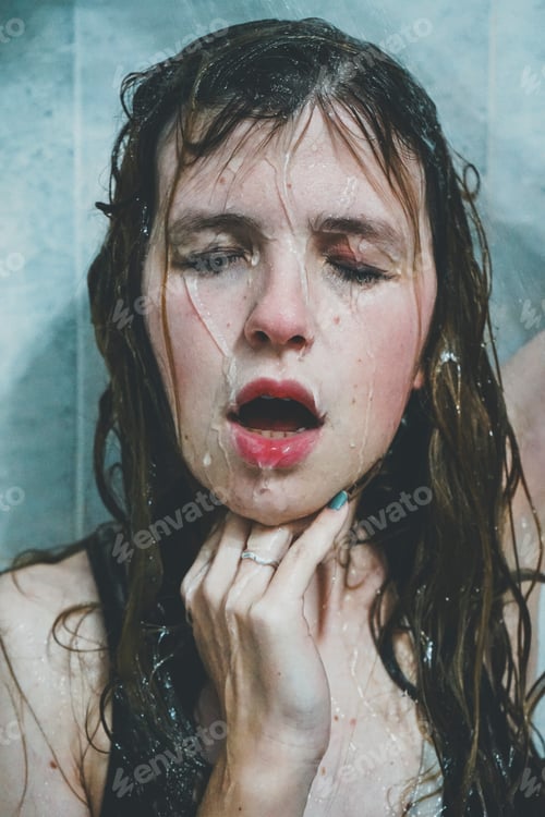 Preview: Artistic portrait of a young woman under shower water