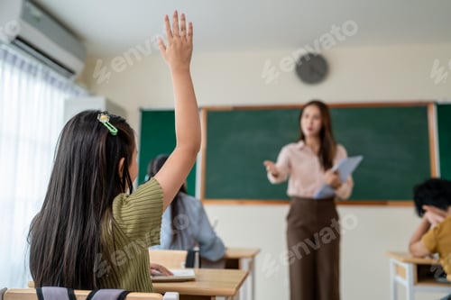 Preview: Asian female teacher educating group of students at elementary school.