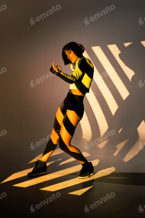 Preview: Sensual woman dancing under bright light