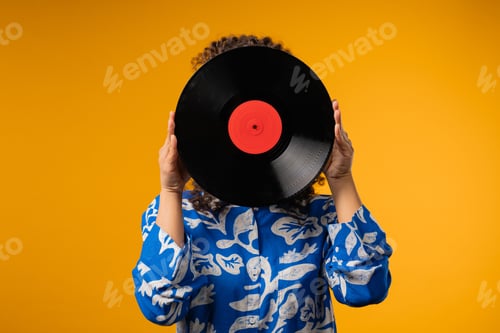 Preview: Young african teen or woman with vinyl record disc. Hobby,Music Lover,Collection
