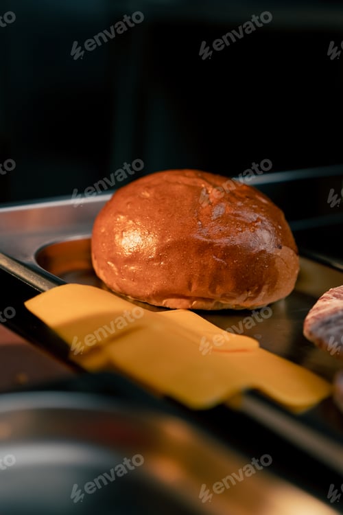 Preview: close-up on the kitchen table of the establishment there is a half of burger bun next to the cheese
