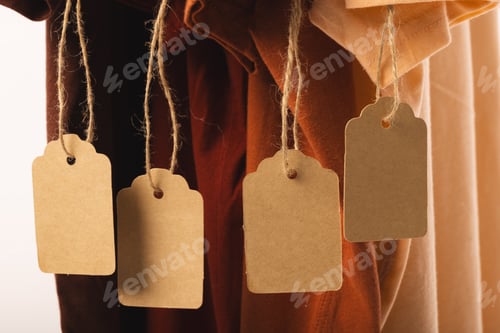 Preview: Four t shirts with tags and copy space on white background