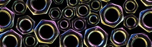 Preview: panoramic shot of scattered small and big metal nuts isolated on black