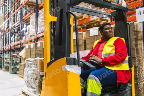 Preview: Warehouse worker driving forklift arranging goods on shelves
