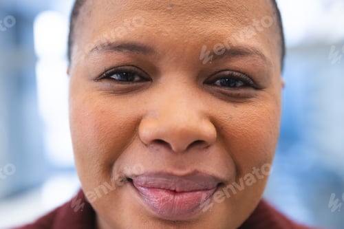 Preview: Portrait of happy african american female patient in waiting room at hospital