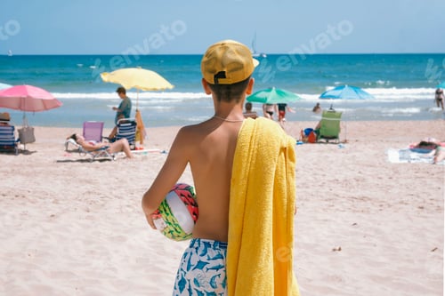 Preview: Teenager enjoying a fabulous day at the beach playing with the ball.