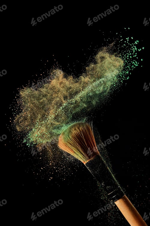 Preview: cosmetic brush with green and orange powder on black background
