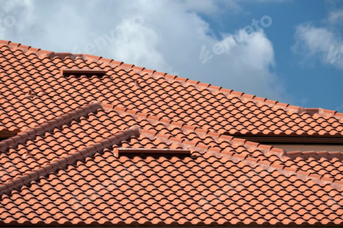 Preview: House rooftop covered with yellow ceramic shingles. Tiled covering of residential apartment building