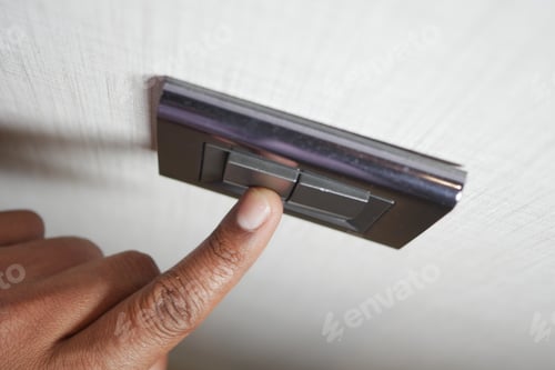 Preview: A finger turning on lighting switch .