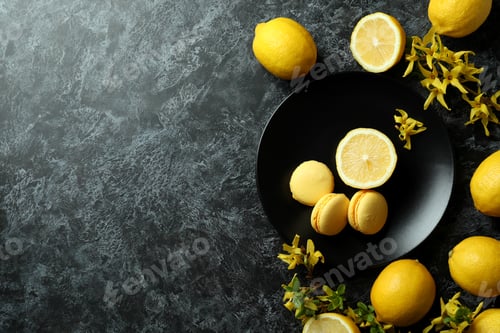 Preview: Macaroons, lemons and flowers on black smokey background