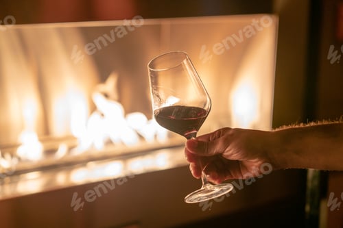 Preview: Close up of glasses of vodka, rum and red whine against fire pit