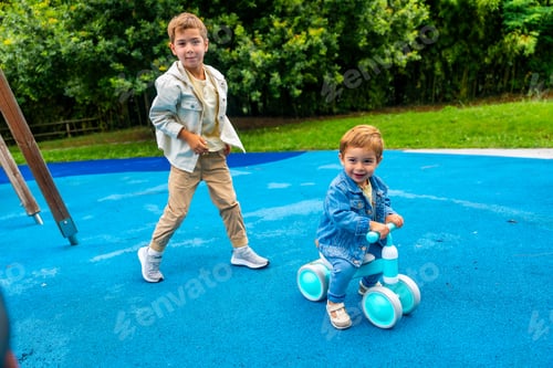 Preview: Children playing in the playground with balance bike and walking on blue rubber flooring