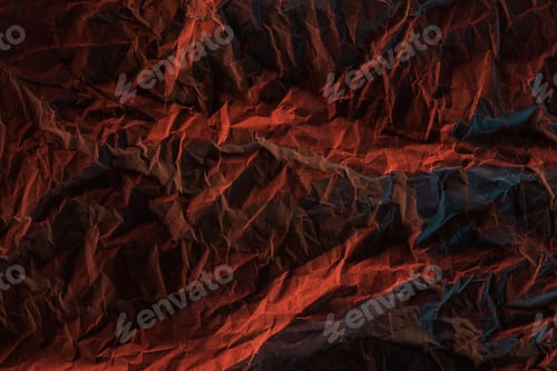 Preview: top view of crumpled paper with red colorful lighting in darkness