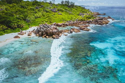 Preview: Tropical beach Anse Cocos. La Digue island. Seychelles. Drone aerial view of coastline with blue