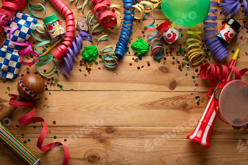 Preview: Carnival background on a wooden surface. Masks, balloons, coiled streamers, confetti and many more