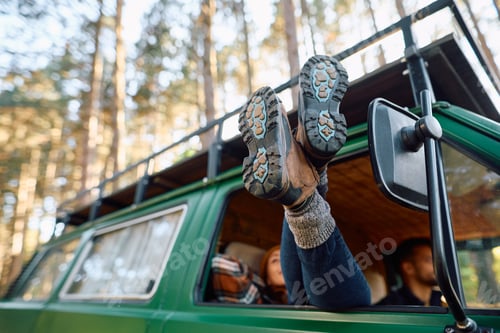 Preview: Close up of woman inside of a travel van in nature.