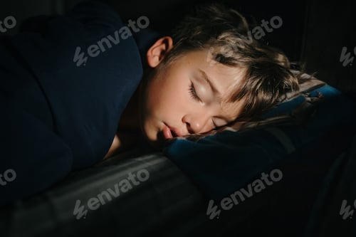 Preview: Young boy sleeping sounding in the early morning light