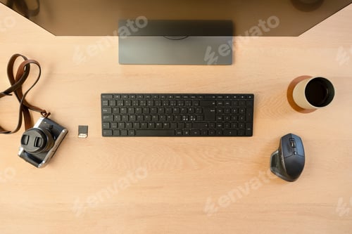 Preview: Top View of Creative Office Desk with Monitor and Camera with Hot Cup of Coffee