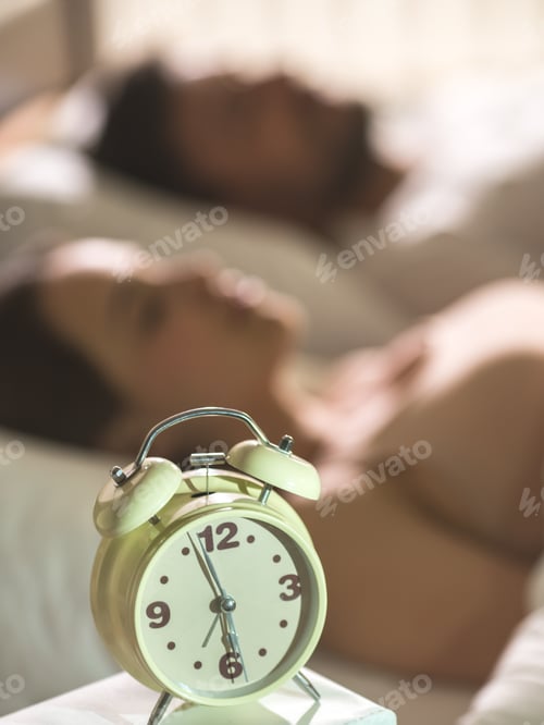Preview: The clock on the background of the sleeping couple
