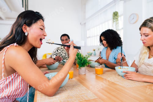 Preview: Multiethnic group of young friends meeting at home and eating poke bowls