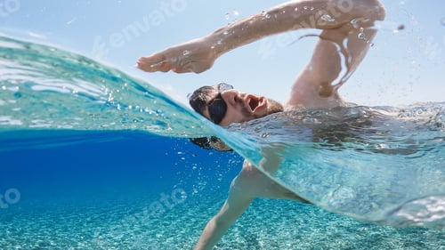 Preview: Man is swimming in the open ocean at Summer.