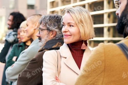Preview: Portrait of an empowered businesswoman surrounded by co-workers in a outdoors portrait