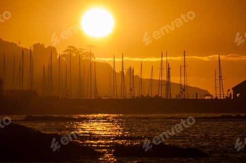 Preview: Silhouette of ships masts against sunset