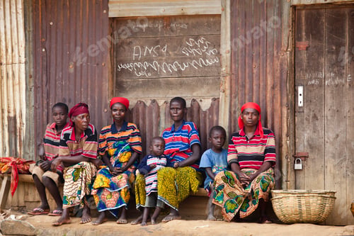Preview: Family sitting together outside their home